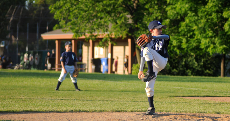 Little league pitcher throwing the ball