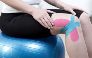 physical therapist using kinesiology tape