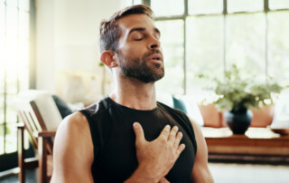 man with hand on heart taking a breath